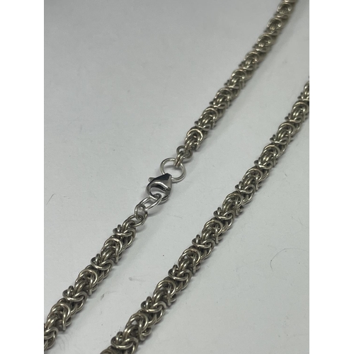 560 - A MARKED SILVER ORNATE NECKLACE