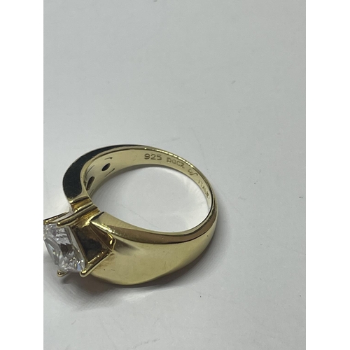 606 - A SILVER GILT RING WITH CLEARSTONE AND A PAIR OF EARRINGS