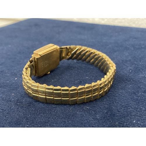 512 - AN 18CT GOLD CASED LADIES WATCH ON A ROLLED GOLD BRACELET