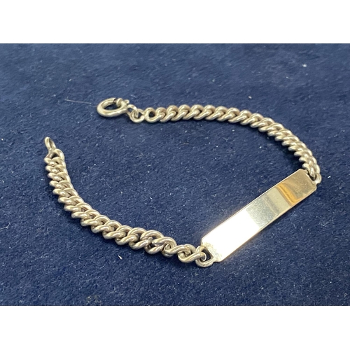 554 - A SILVER ID BRACELET ON A CURB LINK CHAIN