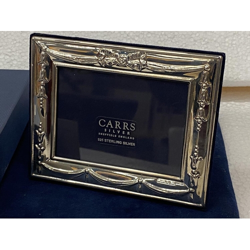 556 - A BOXED HALLMARKED SHEFFIELD SILVER PHOTO FRAME