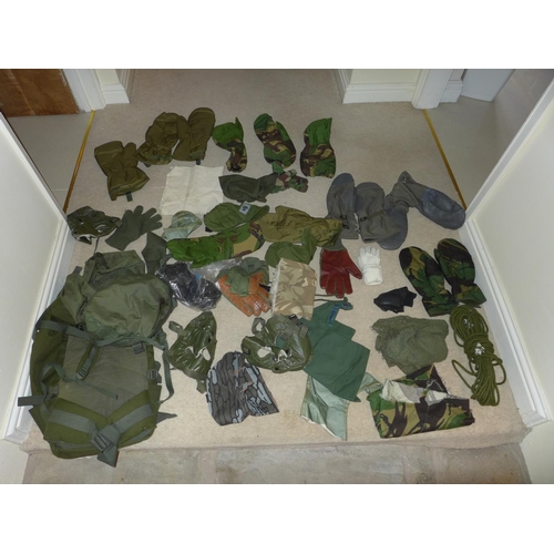 380 - A MILITARY KIT BAG CONTAINING CAMOUFLAGED MASKS, ROPE, GLOVES ETC