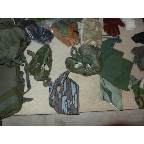 380 - A MILITARY KIT BAG CONTAINING CAMOUFLAGED MASKS, ROPE, GLOVES ETC