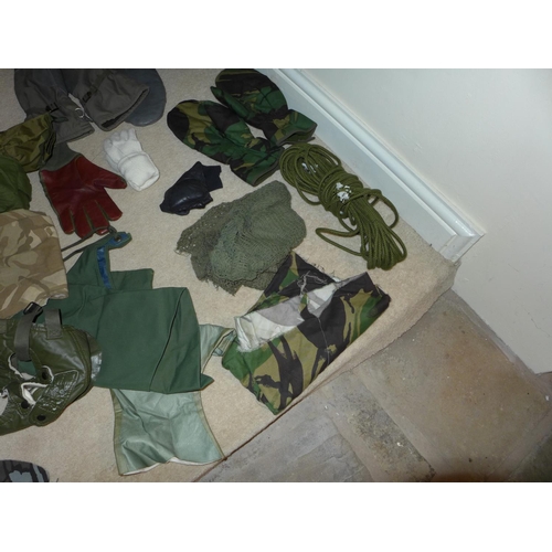 380 - A MILITARY KIT BAG CONTAINING CAMOUFLAGED MASKS, ROPE, GLOVES ETC