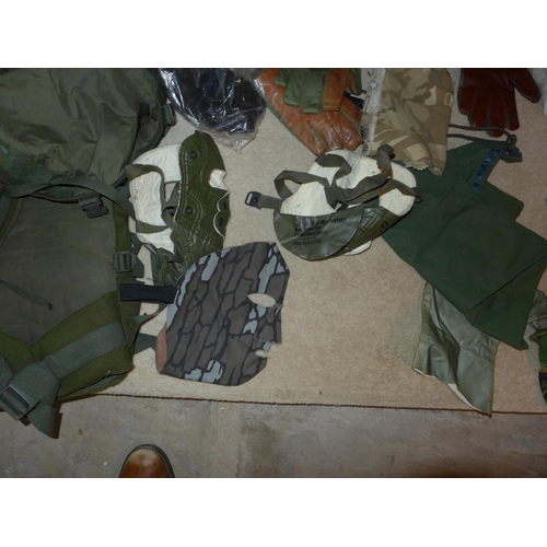 380 - A MILITARY KIT BAG CONTAINING CAMOUFLAGED MASKS, ROPE, GLOVES ETC