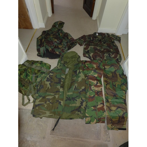 387 - A COLLECTION OF MILITARY/SHOOTING/FISHING CAMOUFLAGE UNIFORMS AND A MILITARY RUCKSACK