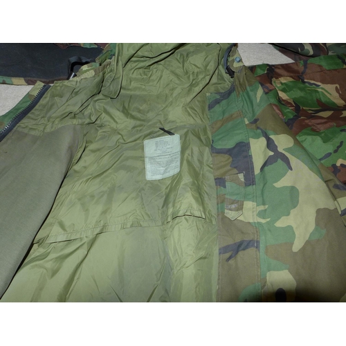 387 - A COLLECTION OF MILITARY/SHOOTING/FISHING CAMOUFLAGE UNIFORMS AND A MILITARY RUCKSACK