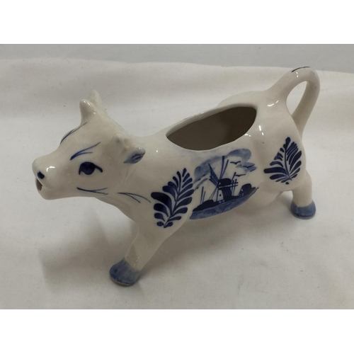 110 - A DELFT BLUE HANDPAINTED COW CREAMER AND A JERSEY COW CREAMER