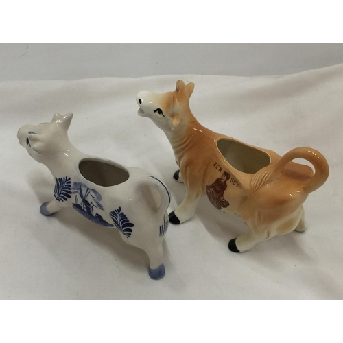 110 - A DELFT BLUE HANDPAINTED COW CREAMER AND A JERSEY COW CREAMER