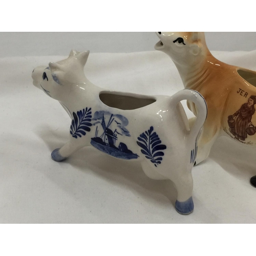 110 - A DELFT BLUE HANDPAINTED COW CREAMER AND A JERSEY COW CREAMER