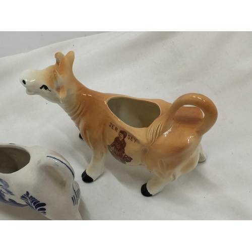 110 - A DELFT BLUE HANDPAINTED COW CREAMER AND A JERSEY COW CREAMER