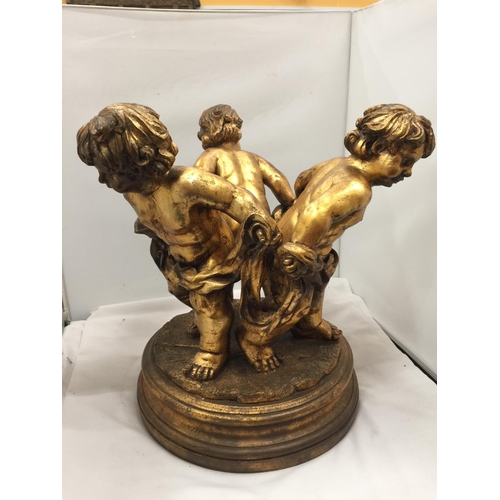 64 - A LARGE GILT COLOURED CHERUBS STAND HEIGHT 44CM, DIAMETER APPROX 34CM