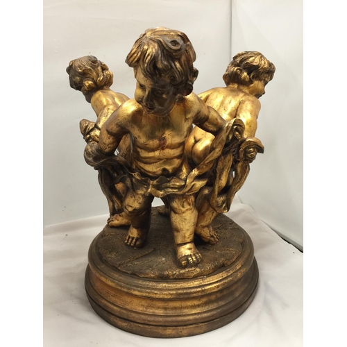 64 - A LARGE GILT COLOURED CHERUBS STAND HEIGHT 44CM, DIAMETER APPROX 34CM