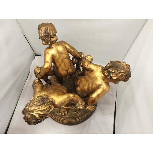 64 - A LARGE GILT COLOURED CHERUBS STAND HEIGHT 44CM, DIAMETER APPROX 34CM