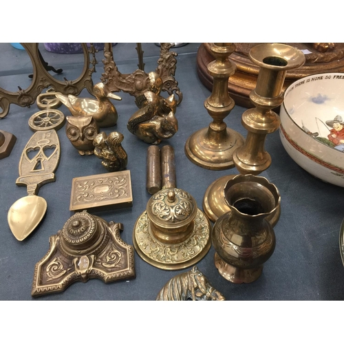 65 - A LARGE QUANTITY OF BRASSWARE TO INCLUDE CANDLESTICKS, INKWELLS, PHOTO FRAMES, ANIMALS, TRINKET BOXE... 