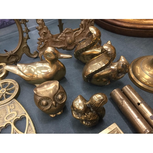 65 - A LARGE QUANTITY OF BRASSWARE TO INCLUDE CANDLESTICKS, INKWELLS, PHOTO FRAMES, ANIMALS, TRINKET BOXE... 