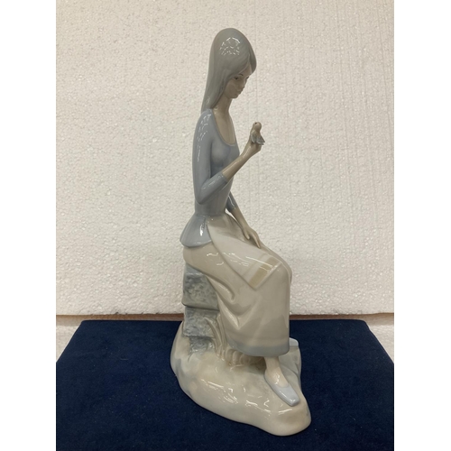 724 - A MIQUEL REQUENA LLADRO STYLE PORCELAIN FIGURINE OF A SITTING GIRL WITH A BIRD IN HER HAND - 28CM IN... 