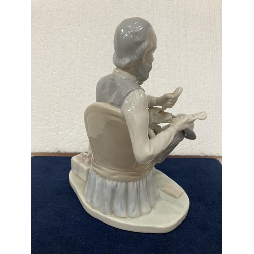 725 - A PORCELAIN FIGURINE OF A GENTLEMAN WITH DOG SMOKING A PIPE WHILST READING THE NEWSPAPER - SMALL CHI... 