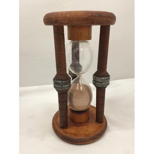 86 - A LARGE VINTAGE WOODEN HOURGLASS HEIGHT 24CM