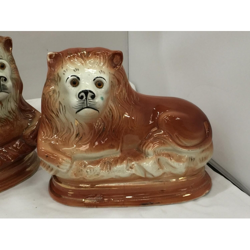 93 - A PAIR OF MID CENTURY SADLER, BURSLEM RECLINING LIONS WITH GLASS EYES - A/F CHIPS TO BASE