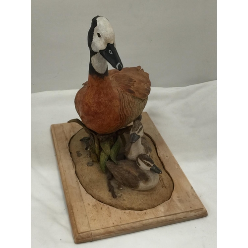 94 - A DAVID TOMLINSON CERAMIC WHITE FACED DUCK WITH DUCKLINGS, SIGNED TO THE BASE, HEIGHT APPROX 31CM, L... 