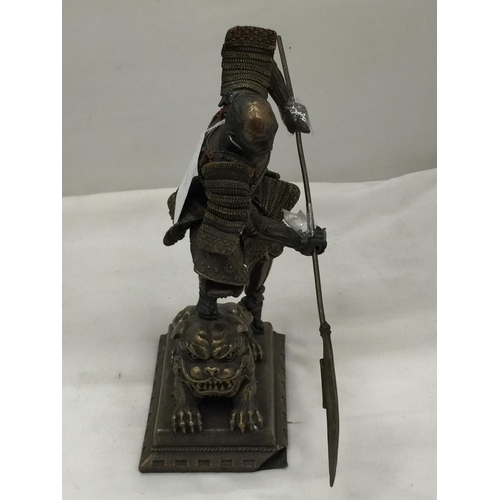 97 - A METAL FIGURE OF A SAMURAI WARRIOR STANDING ON A LION HEIGHT 24CM