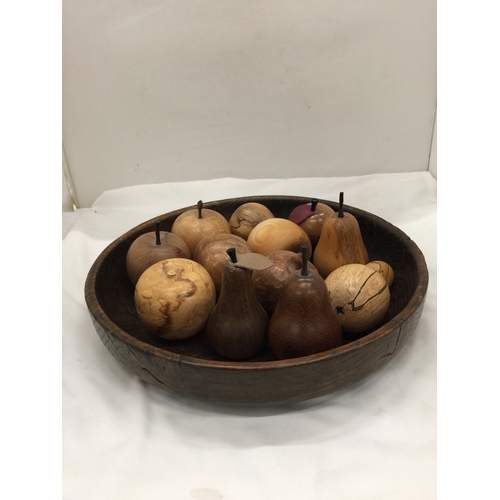 121 - A LARGE TREEN BOWL CONTAINING A QUANTITY OF CARVED FRUITS