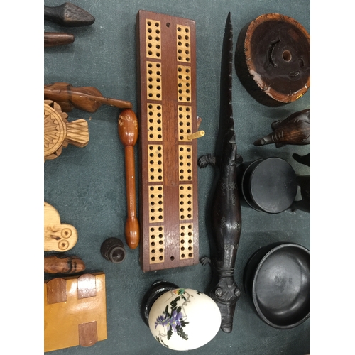 127 - A QUANTITY OF TREEN ITEMS TO INCLUDE NUTCRACKERS, A CRIBBAGE BOARD, LETTER OPENERS, ETC