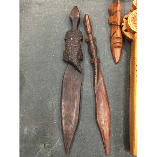 127 - A QUANTITY OF TREEN ITEMS TO INCLUDE NUTCRACKERS, A CRIBBAGE BOARD, LETTER OPENERS, ETC