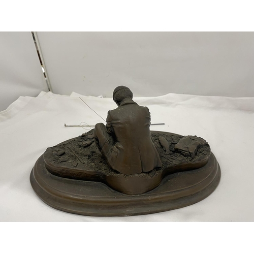 31 - A CROUCHING MAN FISHING WITH ROD ON A WOODEN PLINTH W: 28CM