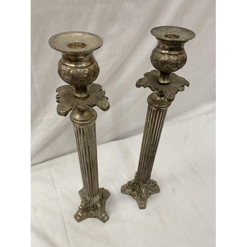 48 - A PAIR OF SILVER PLATED CANDLESTICKS WITH COLUMN DECORATION HEIGHT 45.5CM