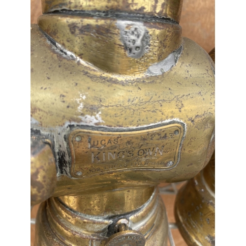 1230 - A NEAR PAIR OF VINTAGE BRASS PARAFIN LAMPS