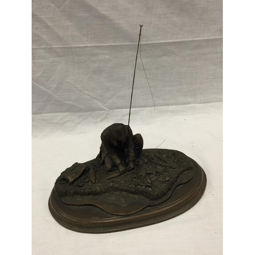 31 - A CROUCHING MAN FISHING WITH ROD ON A WOODEN PLINTH W: 28CM