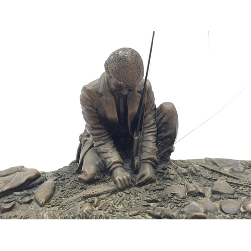 31 - A CROUCHING MAN FISHING WITH ROD ON A WOODEN PLINTH W: 28CM