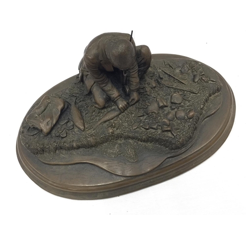 31 - A CROUCHING MAN FISHING WITH ROD ON A WOODEN PLINTH W: 28CM