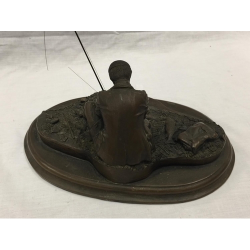 31 - A CROUCHING MAN FISHING WITH ROD ON A WOODEN PLINTH W: 28CM