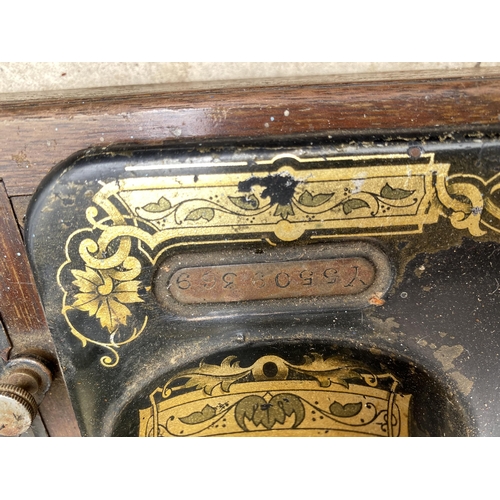 1308 - A VINTAGE SINGER SEWING MACHINE WITH WOODEN CARRY CASE