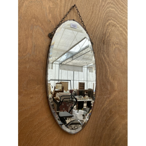 1247 - AN OVAL ART DECO BEVELED EDGE WALL MIRROR WITH HANGING CHAIN