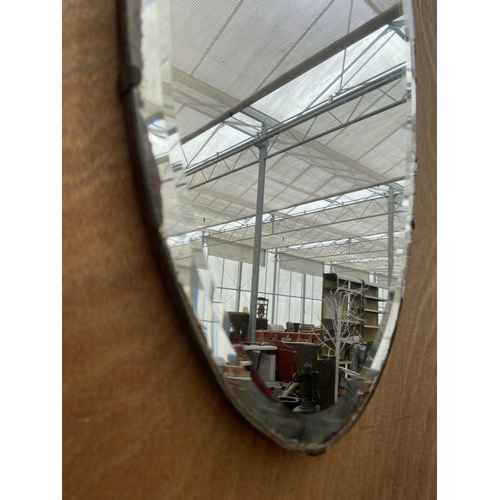 1247 - AN OVAL ART DECO BEVELED EDGE WALL MIRROR WITH HANGING CHAIN