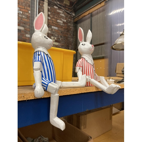 257 - A PAIR OF SHELF RABBITS WITH STRIPED JACKETS HEIGHT 46CM