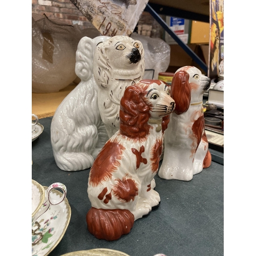 269 - A PAIR OF RED AND WHITE STAFFORDSHIRE MANTLE DOGS HEIGHT 18CM PLUS TWO WHITE ONES HEIGHT 24CM