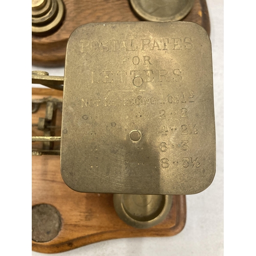 281 - TWO SETS OF WOOD AND BRASS POSTAL SCALES WITH WEIGHTS