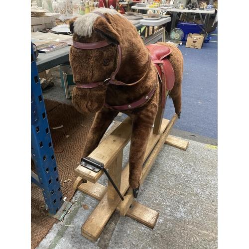 351 - A VINTAGE ROCKING HORSE ON A WOODEN ROCKING BASE WITH RED SADDLE HEIGHT TO SADDLE APPROX 75CM