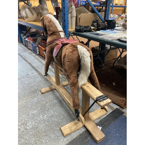 351 - A VINTAGE ROCKING HORSE ON A WOODEN ROCKING BASE WITH RED SADDLE HEIGHT TO SADDLE APPROX 75CM