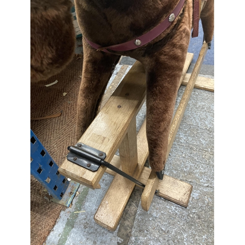 351 - A VINTAGE ROCKING HORSE ON A WOODEN ROCKING BASE WITH RED SADDLE HEIGHT TO SADDLE APPROX 75CM