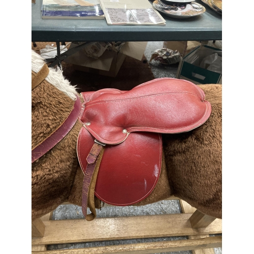 351 - A VINTAGE ROCKING HORSE ON A WOODEN ROCKING BASE WITH RED SADDLE HEIGHT TO SADDLE APPROX 75CM