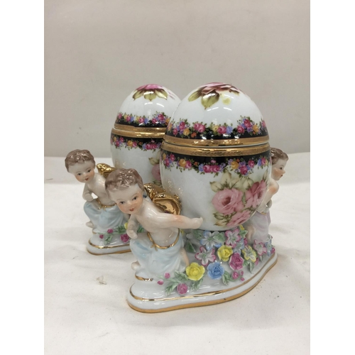 151 - A PAIR OF RENAISSANCE STYLE ORNATE TRINKET BOXES WITH CHERUBS PLUS A FLORAL CERAMIC MANTLE CLOCK