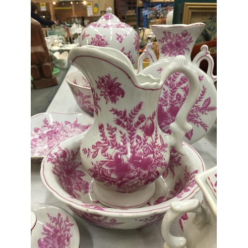 155 - A PINK AND WHITE FLORAL PATTERN BATHROOM SET TO INCLUDE JUG AND BOWL, CANDLESTICK, LARGE BOWL, LARGE... 