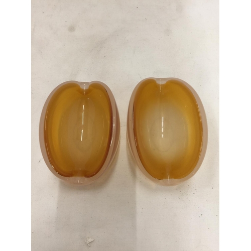 167 - A PAIR OF OVAL SHAPED GLASS BOWLS WITH AN AMBER INTERIOR AND AN OPAQUE EXTERIOR