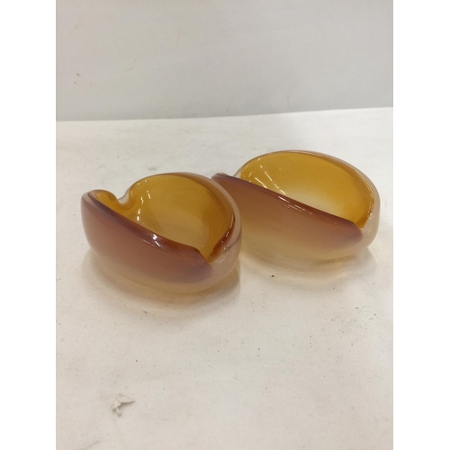 167 - A PAIR OF OVAL SHAPED GLASS BOWLS WITH AN AMBER INTERIOR AND AN OPAQUE EXTERIOR